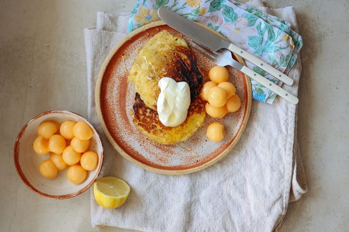 Lemon ricotta hotcakes with rockmelon balls