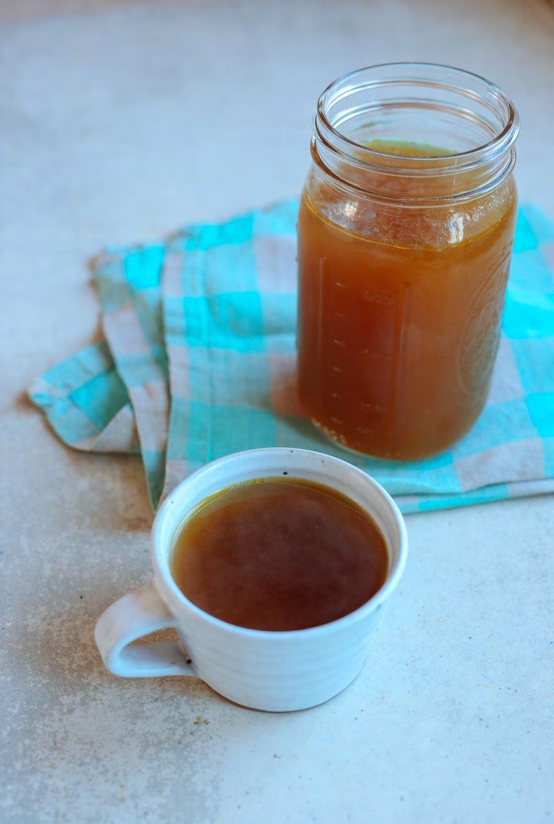 Roasted vegetable broth in a mug and jar
